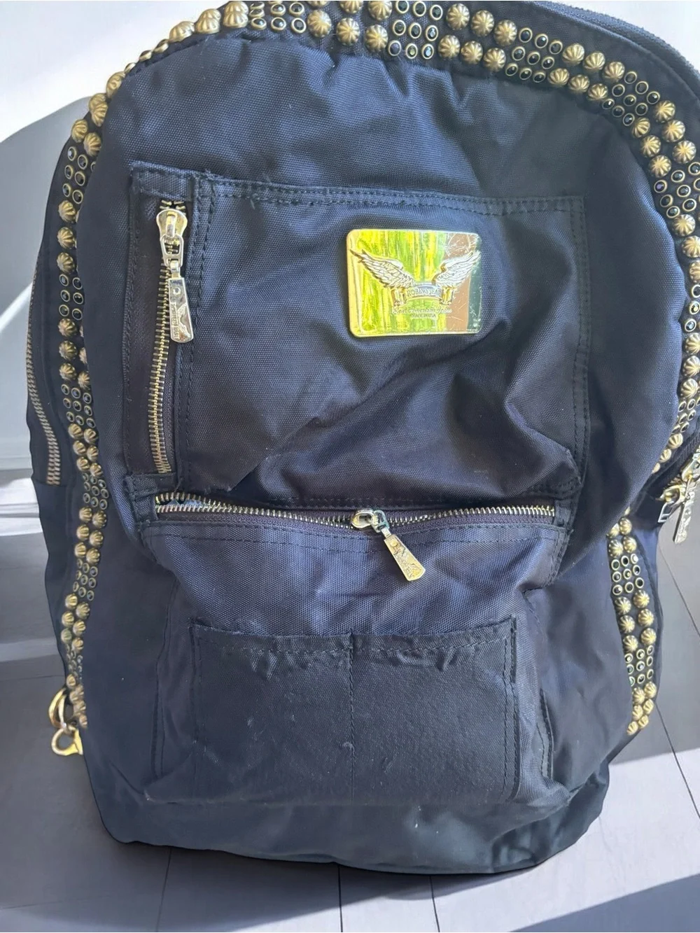 Jean Studded Backpack designed with an edgy  streetwear aesthetic.